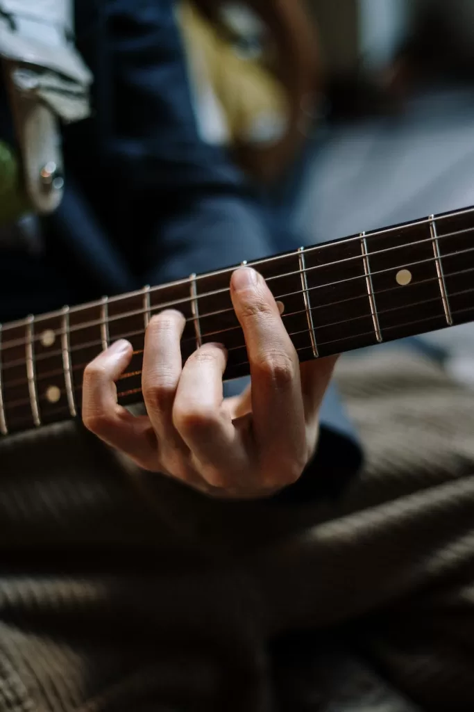 person playing guitar in black shirt