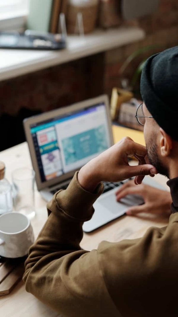 backview of man using laptop